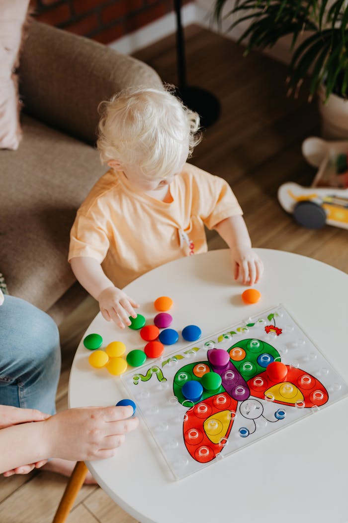 Mastering the First Impression: Your intriguing post title goes here A child with light hair enjoys a colorful educational toy indoors, promoting learning and development.